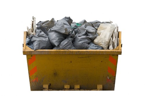 Commercial skip being loaded with waste in Dulwich